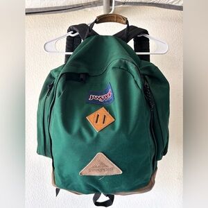 Vintage Green Jansport Backpack with Side Pockets and Leather Details
